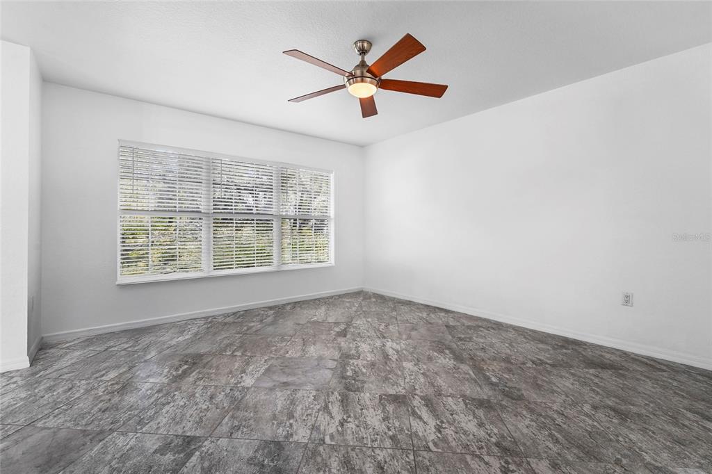 23655 Jennings Road Myakka City, FL 34251 - Photo 34 of 43 an empty room with ceiling fan and window