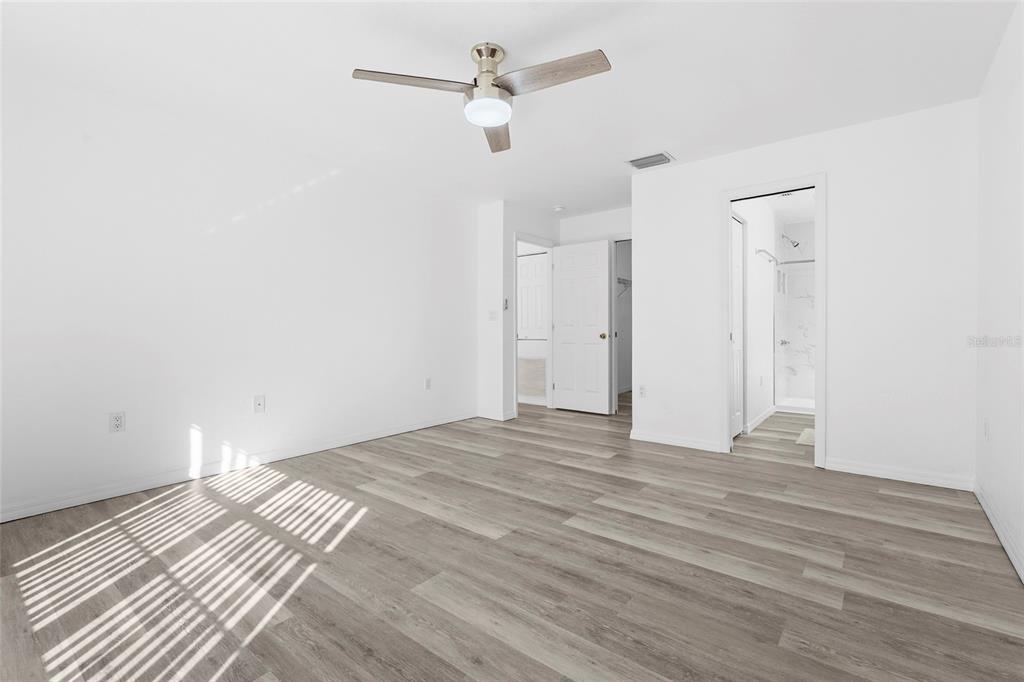23655 Jennings Road Myakka City, FL 34251 - Photo 39 of 43 a view of a bedroom with a bed and a chandelier fan