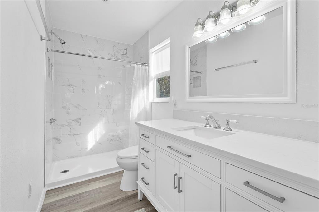 23655 Jennings Road Myakka City, FL 34251 - Photo 10 of 43 a bathroom with a granite countertop sink a toilet and shower