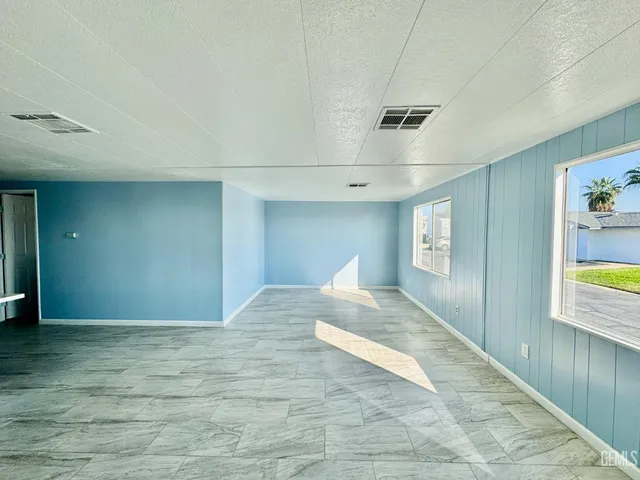a view of hallway with window and wooden floor
