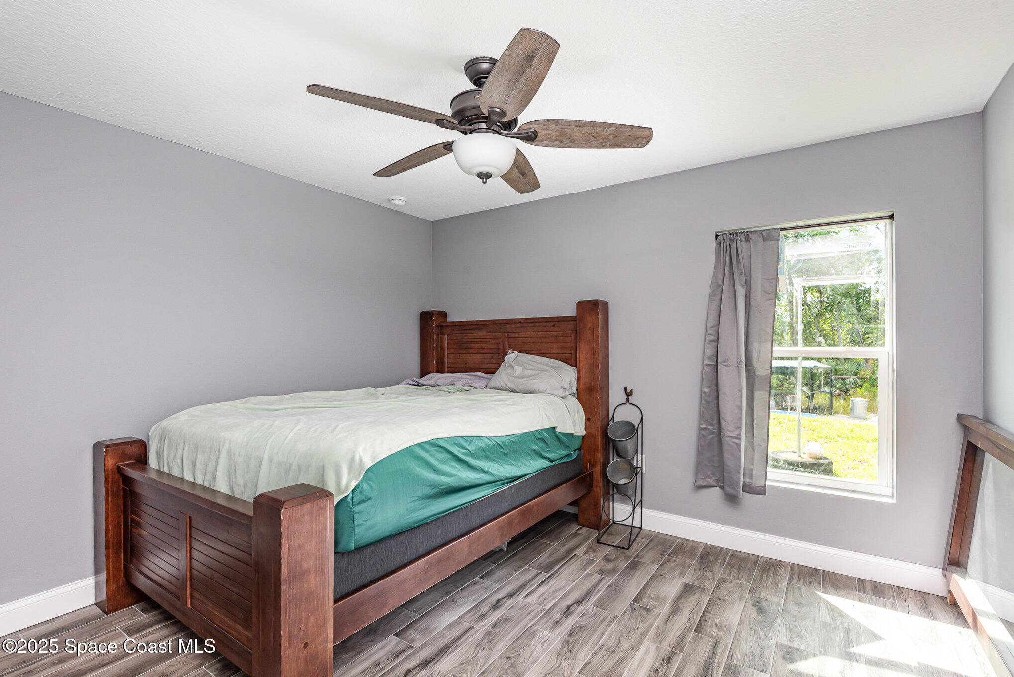 4110 Hog Valley Road Mims, FL 32754 - Photo 12 of 13 a bed sitting in a bedroom next to a window