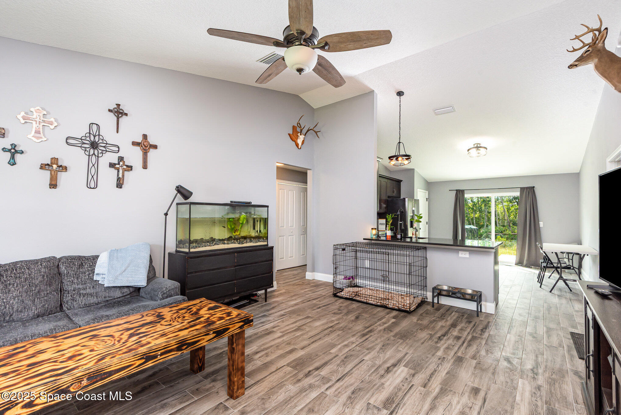 4110 Hog Valley Road Mims, FL 32754 - Photo 3 of 13 a living room with furniture and a flat screen tv