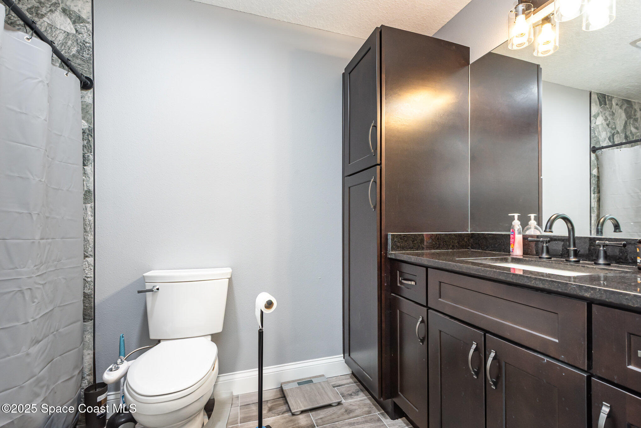 4110 Hog Valley Road Mims, FL 32754 - Photo 8 of 13 a bathroom with a toilet sink and mirror