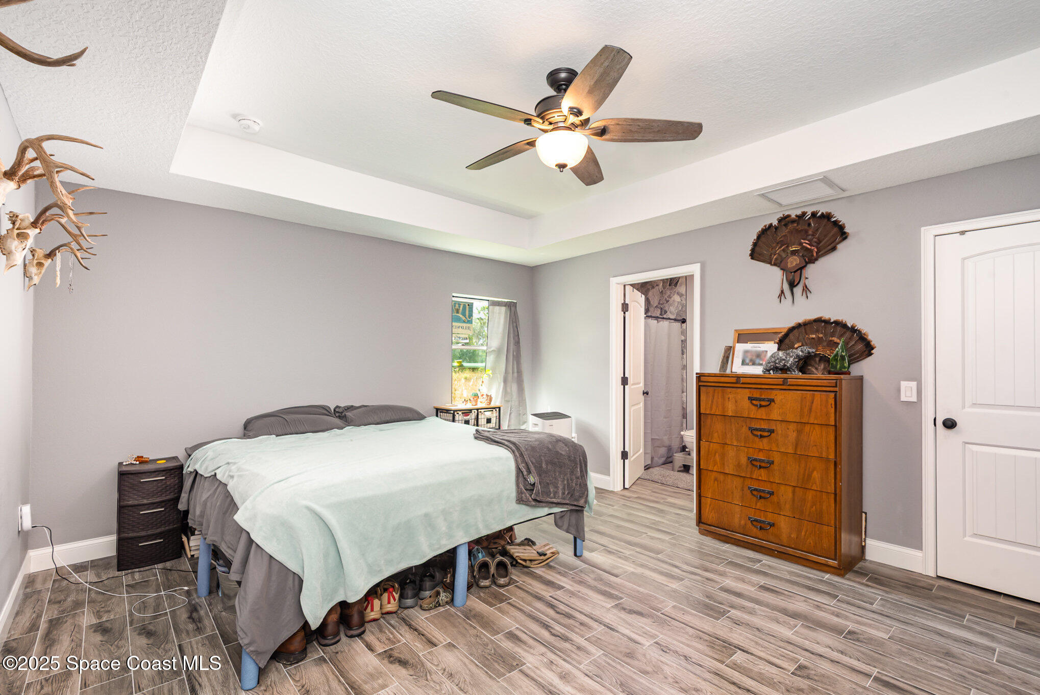 4110 Hog Valley Road Mims, FL 32754 - Photo 9 of 13 a bedroom with a bed and wooden floor