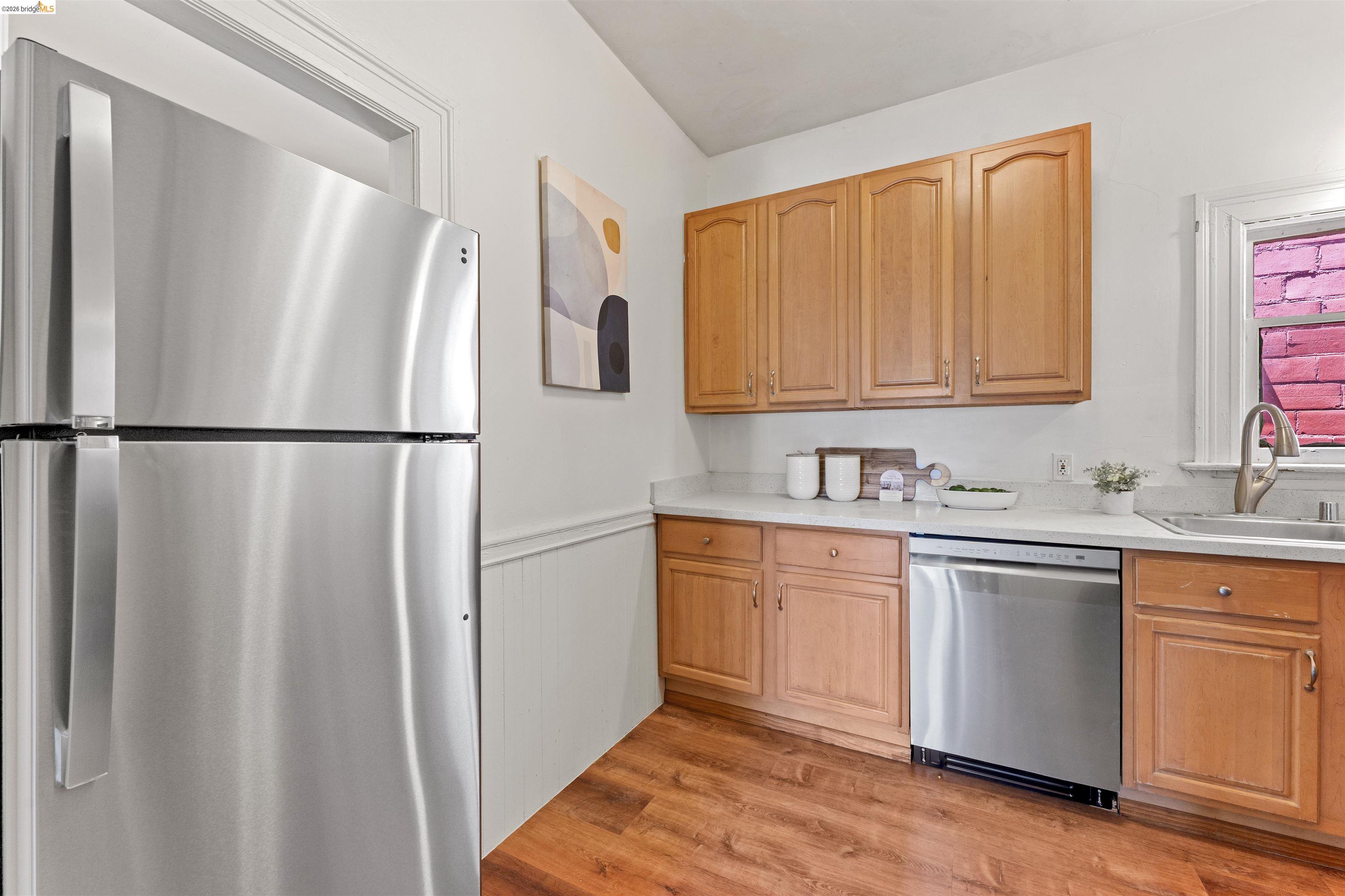 667 10th Street Oakland, CA 94607 - Photo 4 of 15 a kitchen with stainless steel appliances granite countertop a refrigerator and a sink