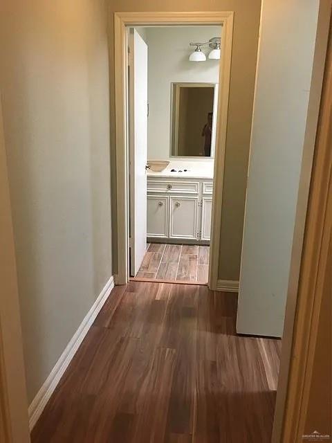 413 Uvalde Avenue McAllen, TX 78503 - Photo 13 of 20 a view of a hallway with wooden floor and a bathroom