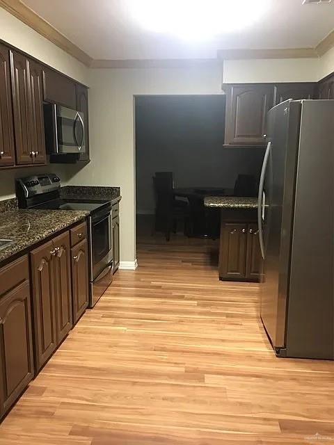 413 Uvalde Avenue McAllen, TX 78503 - Photo 3 of 20 a kitchen with stainless steel appliances granite countertop a stove a sink and a microwave