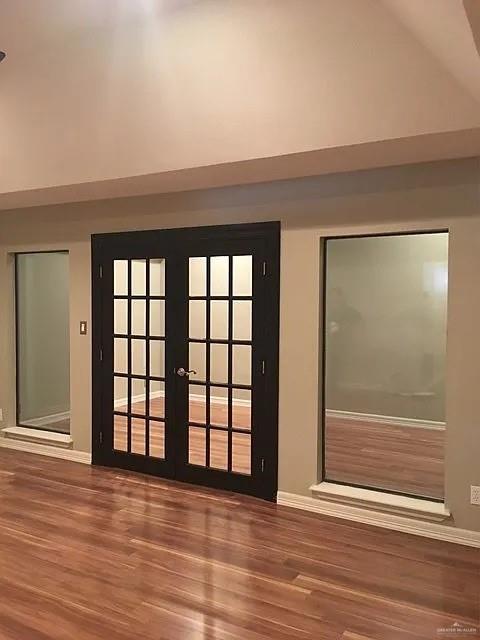 413 Uvalde Avenue McAllen, TX 78503 - Photo 5 of 20 an empty room with wooden floor and windows