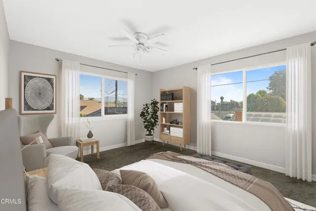 a bedroom with a large bed and a window