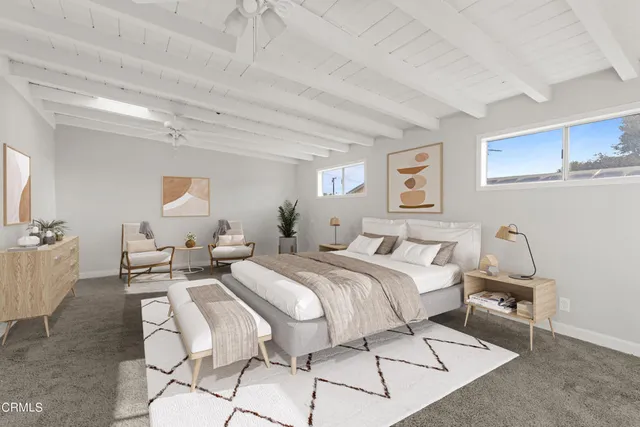 a spacious bedroom with a bed a table and chair