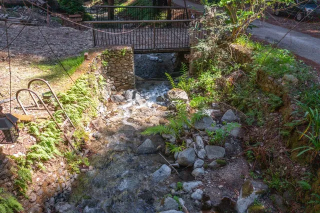 a view of a pathway with a wrought fence