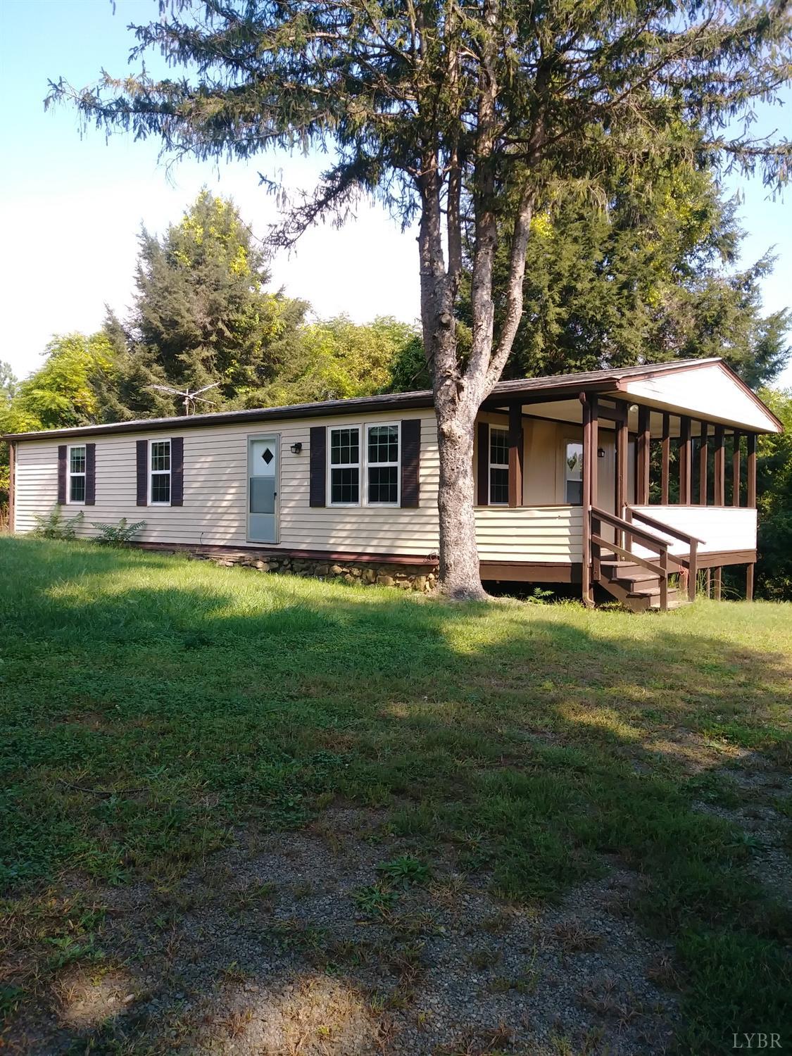 1066 Stevens Cove Road Lovingston, VA 22949 - Photo 1 of 15 a front view of house with yard and green space