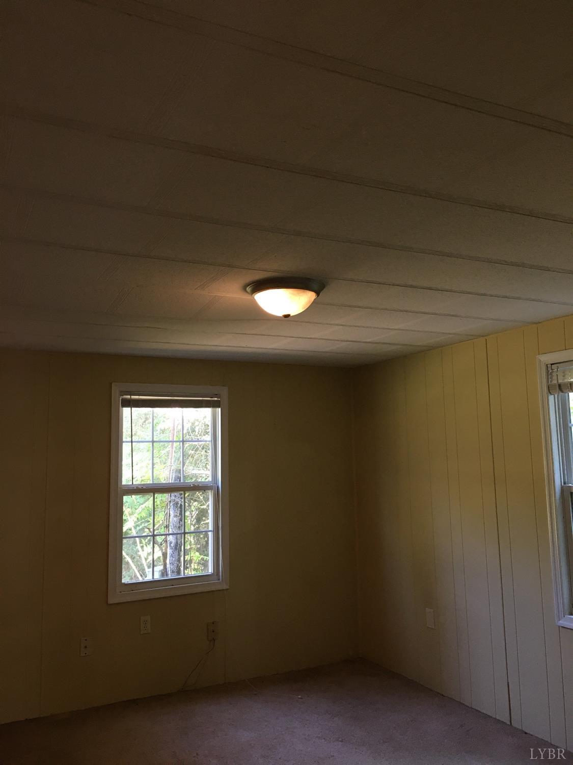 1066 Stevens Cove Road Lovingston, VA 22949 - Photo 13 of 15 a view of an empty room with a window
