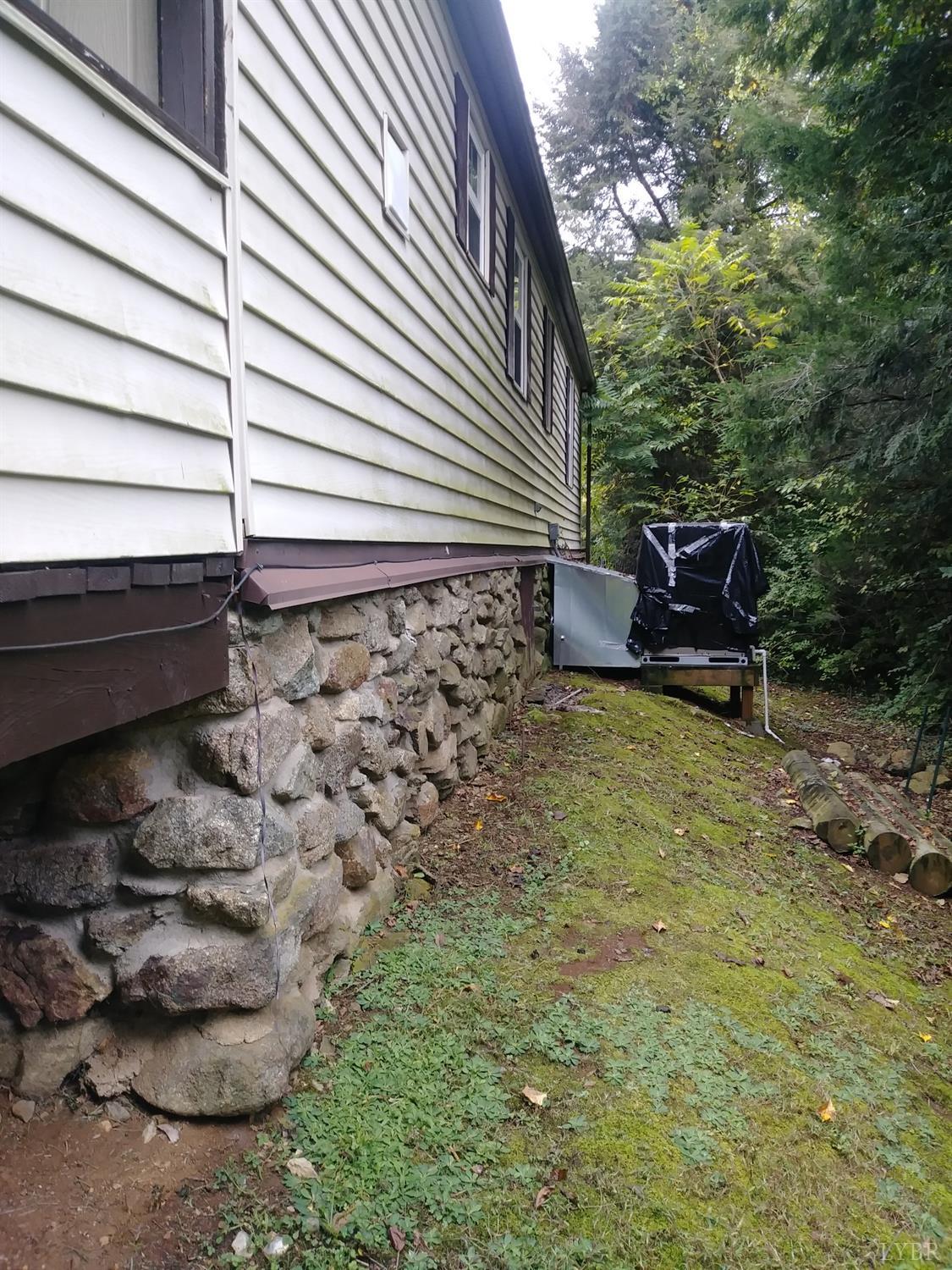 1066 Stevens Cove Road Lovingston, VA 22949 - Photo 15 of 15 a backyard of a house with table and chairs