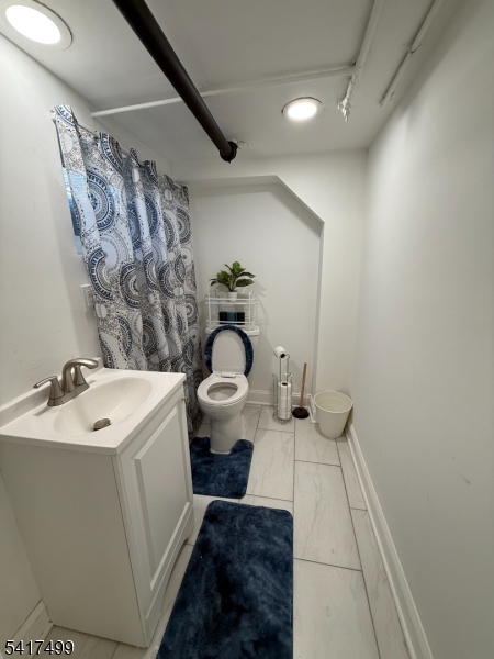 335 Hobson Street Newark, NJ 07112 - Photo 12 of 29 a bathroom with a sink and mirror with toilet