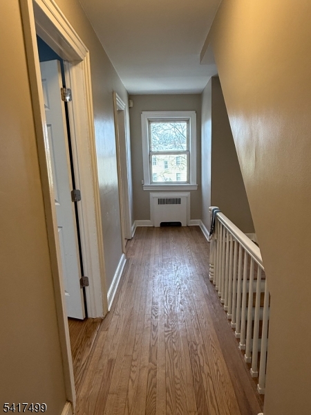 335 Hobson Street Newark, NJ 07112 - Photo 13 of 29 a view of a hallway with wooden floor and stairs