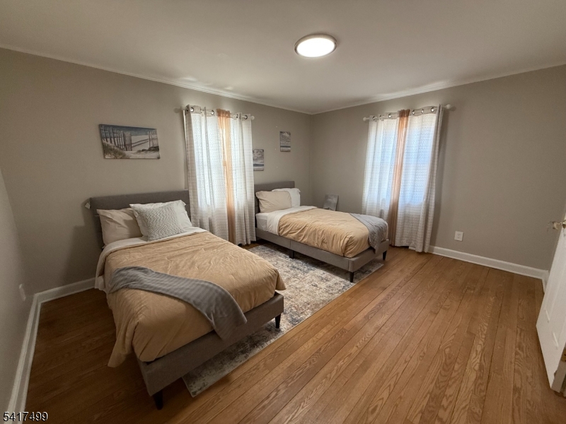 335 Hobson Street Newark, NJ 07112 - Photo 17 of 29 a bedroom with two beds and painting on the wall