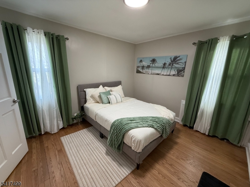 335 Hobson Street Newark, NJ 07112 - Photo 18 of 29 a bedroom with a bed wooden floor and a window