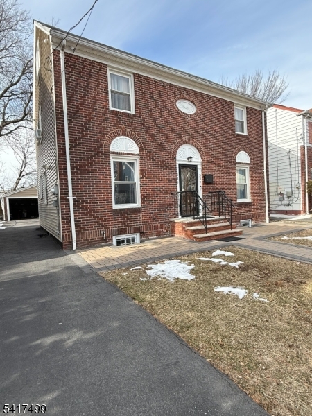 335 Hobson Street Newark, NJ 07112 - Photo 2 of 29 a front view of a house with a yard