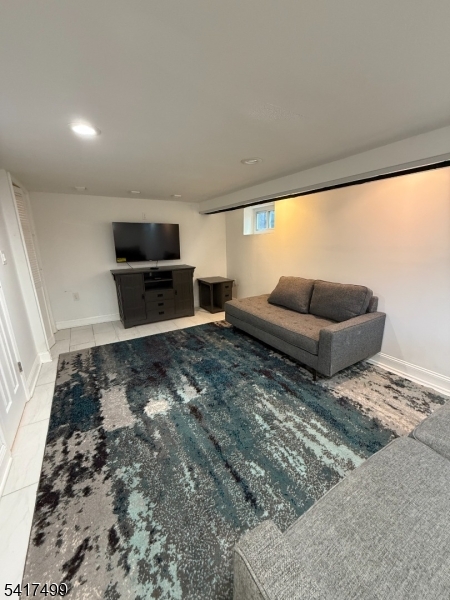 335 Hobson Street Newark, NJ 07112 - Photo 23 of 29 a living room with furniture and a flat screen tv