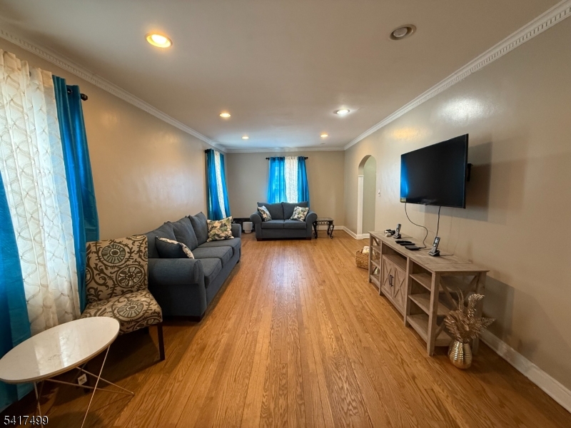 335 Hobson Street Newark, NJ 07112 - Photo 4 of 29 a living room with furniture and a flat screen tv