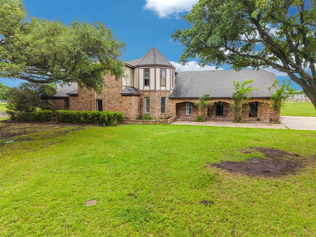 342 East Tripp Road Sunnyvale, TX 75182 - Photo 2 of 5 a view of a house with a big yard and large trees