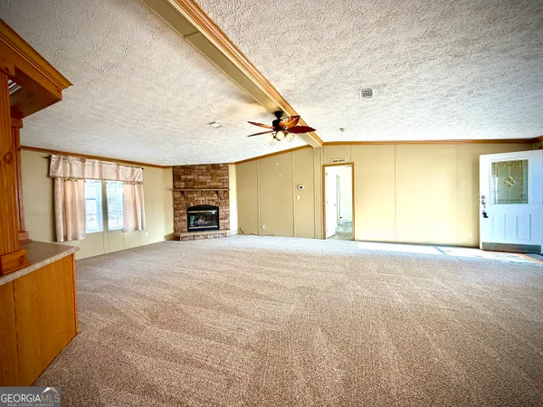 a big room with windows and a fireplace
