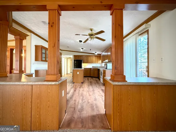 a large kitchen with a large window a counter space and stainless steel appliances