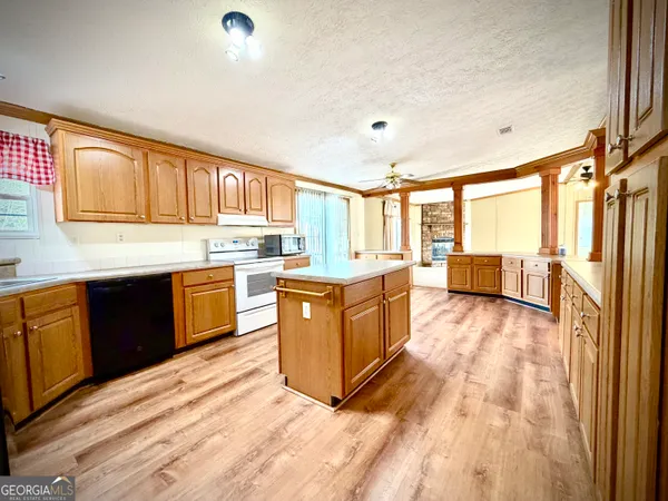 a kitchen with stainless steel appliances granite countertop a stove top oven and refrigerator