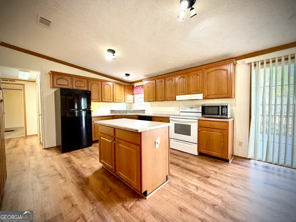 a kitchen with granite countertop cabinets stainless steel appliances and a sink