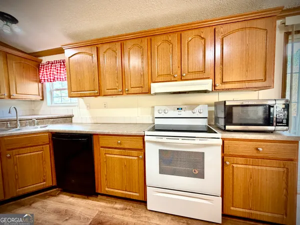 a kitchen with a sink stove and refrigerator