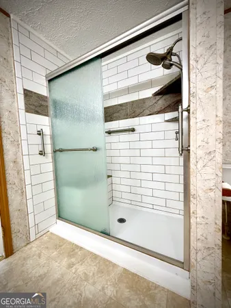a spacious bathroom with a tub sink mirror and a toilet