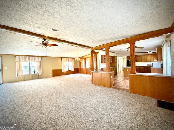 an empty room with wooden floor and a window