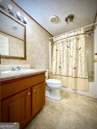 a view of a big room with wooden floor and a window