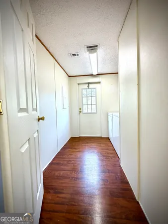 an empty room with a ceiling fan and a large window