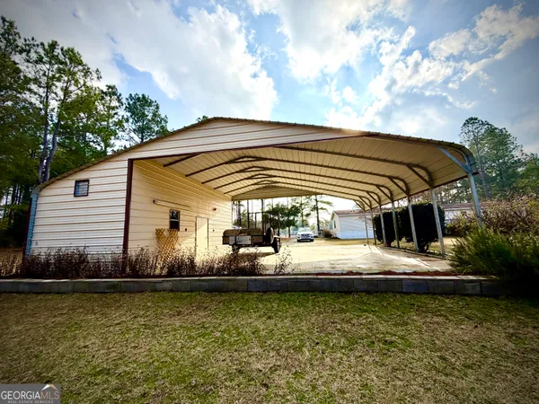 a view of a house with backyard and sitting area