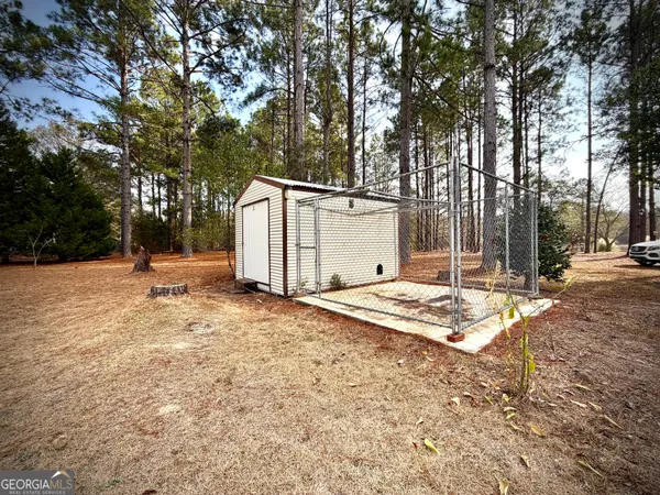 a backyard of a house with a large tree
