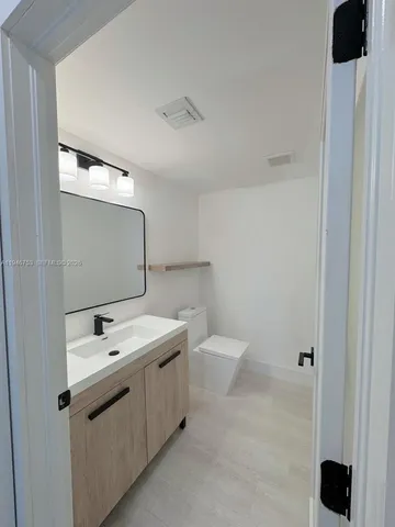 a view of a kitchen with a sink and a refrigerator