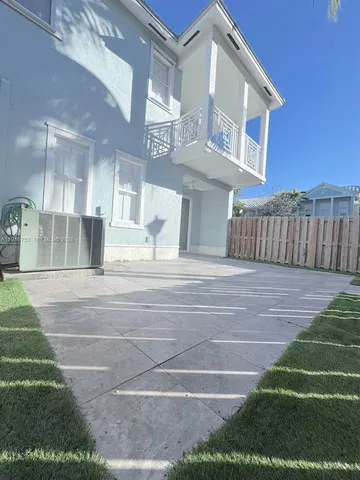 an empty room with wooden floor and a window