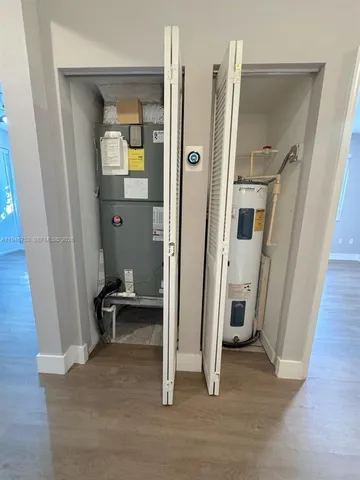 an empty room with windows and closet