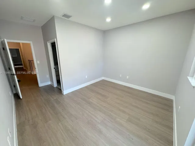 a view of kitchen with windows and refrigerator