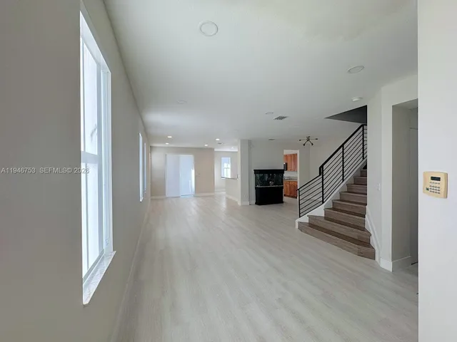 a view of a kitchen with a sink and a refrigerator