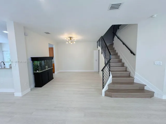a kitchen with stainless steel appliances granite countertop a stove and a sink