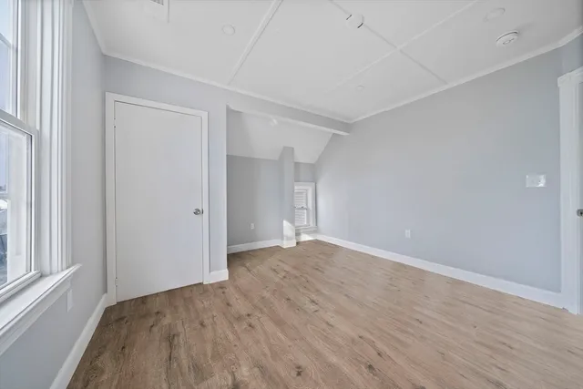 a view of wooden floor and windows in a room