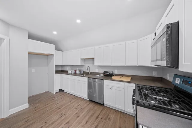 a kitchen with a sink a stove and cabinets