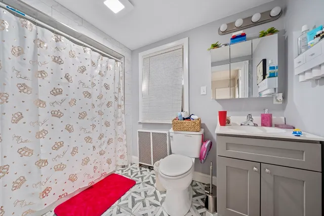 a bathroom with a sink toilet and a shower