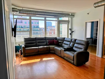 a living room with furniture and a large window