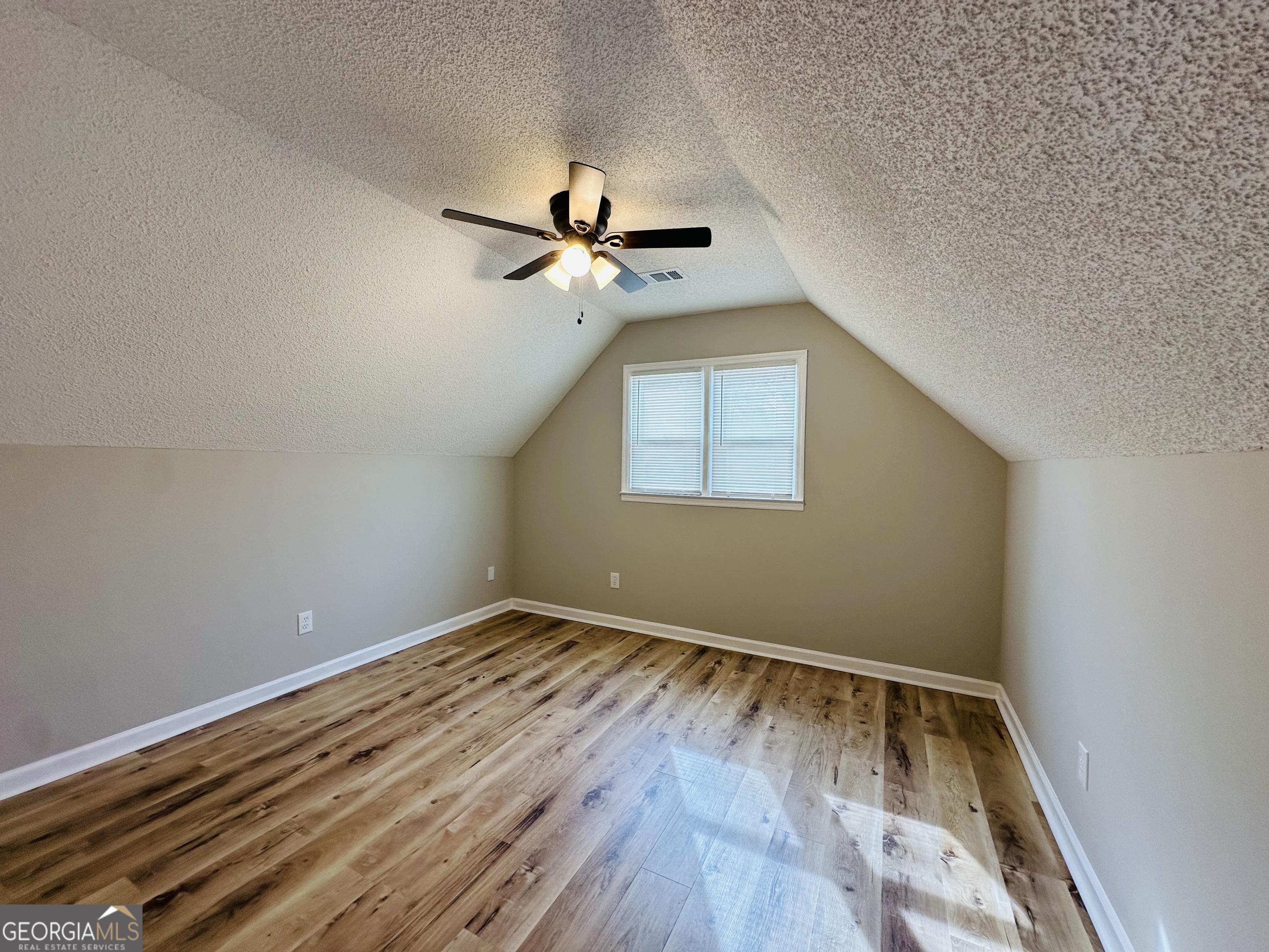 1610 Lance Drive Dublin, GA 31021 - Photo 14 of 38 a view of room with a ceiling fan and wooden floor