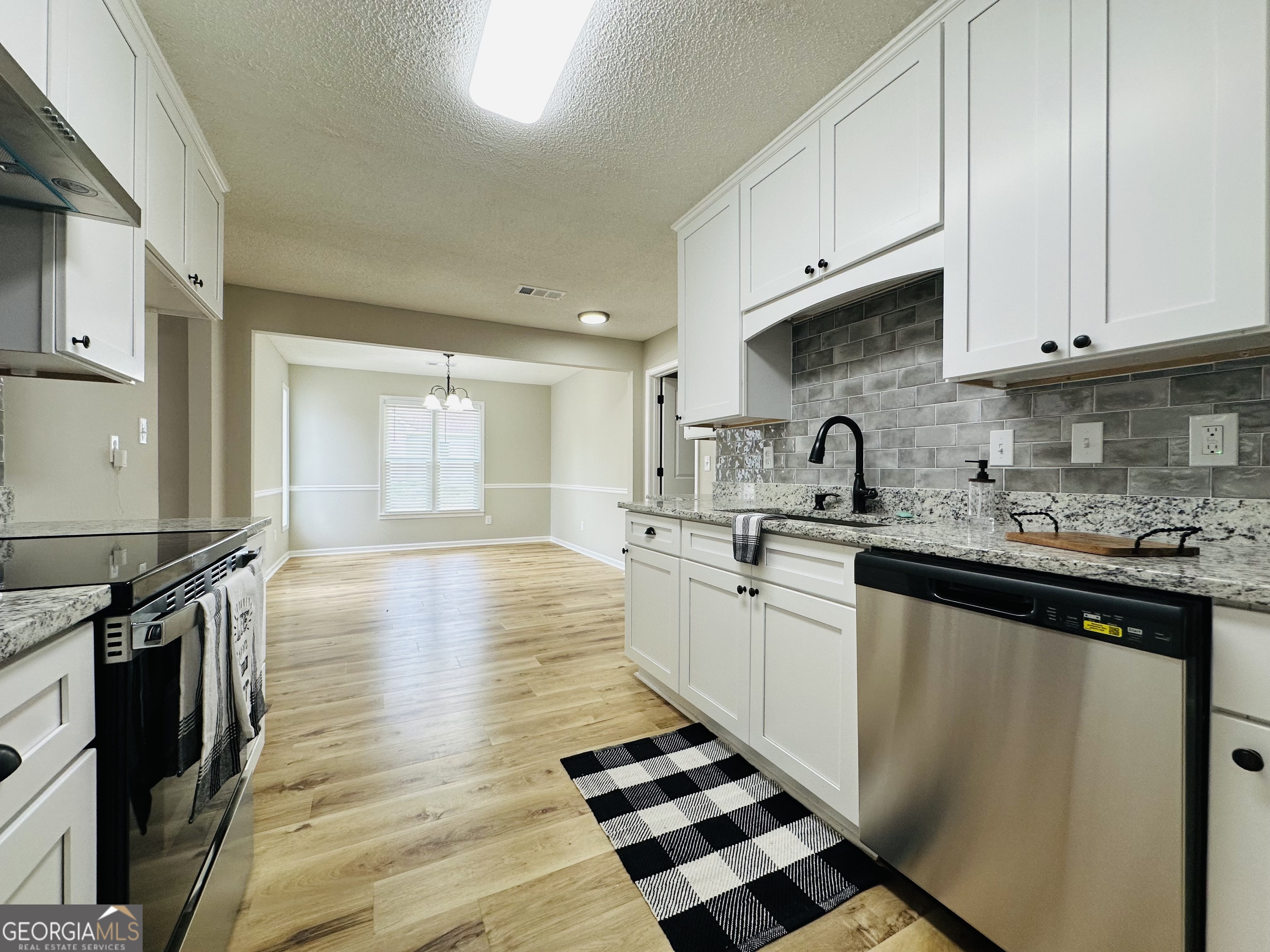 1610 Lance Drive Dublin, GA 31021 - Photo 24 of 38 a kitchen with stainless steel appliances granite countertop a sink stove and cabinets