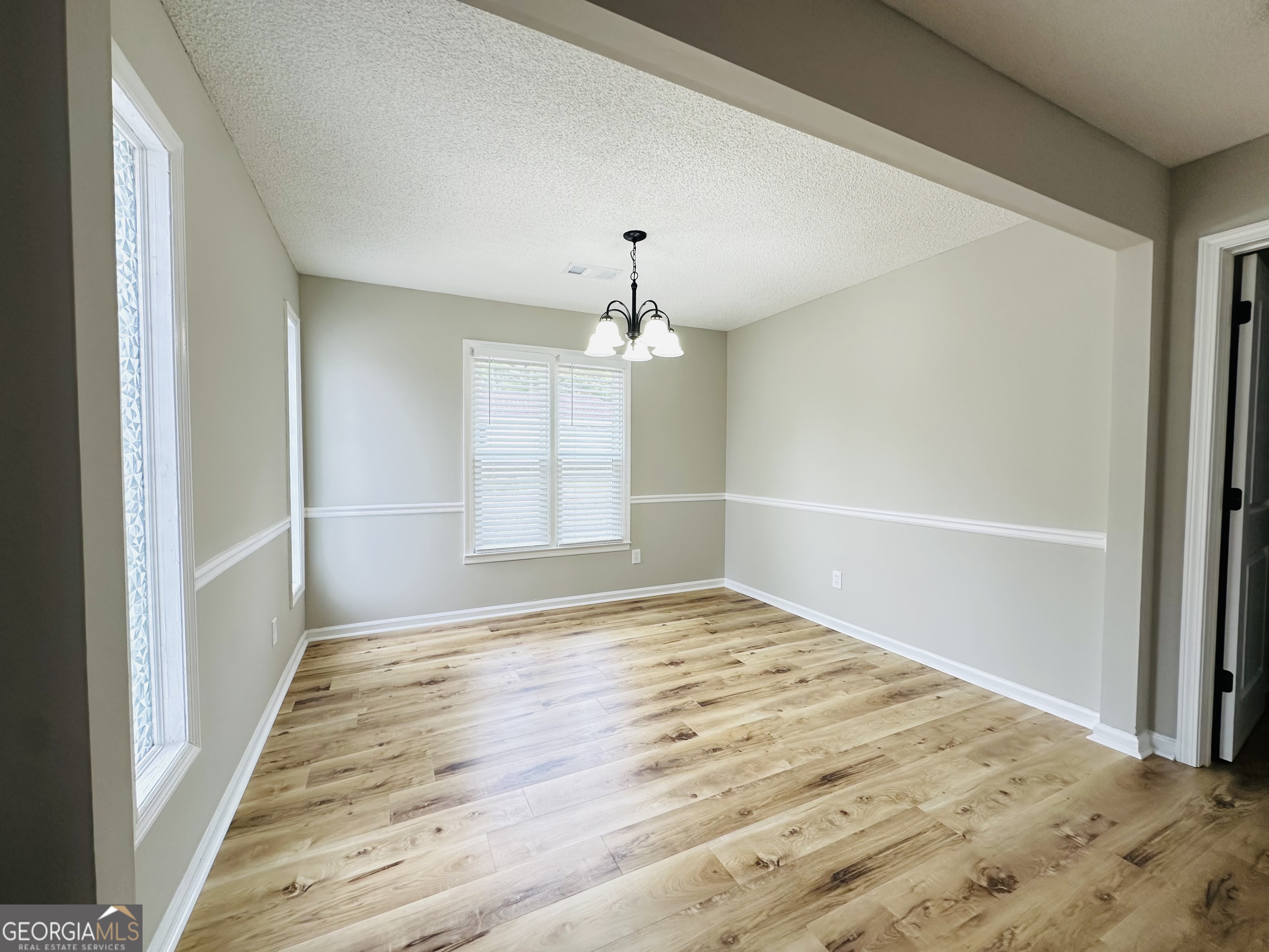 1610 Lance Drive Dublin, GA 31021 - Photo 27 of 38 a view of an empty room with wooden floor and a window
